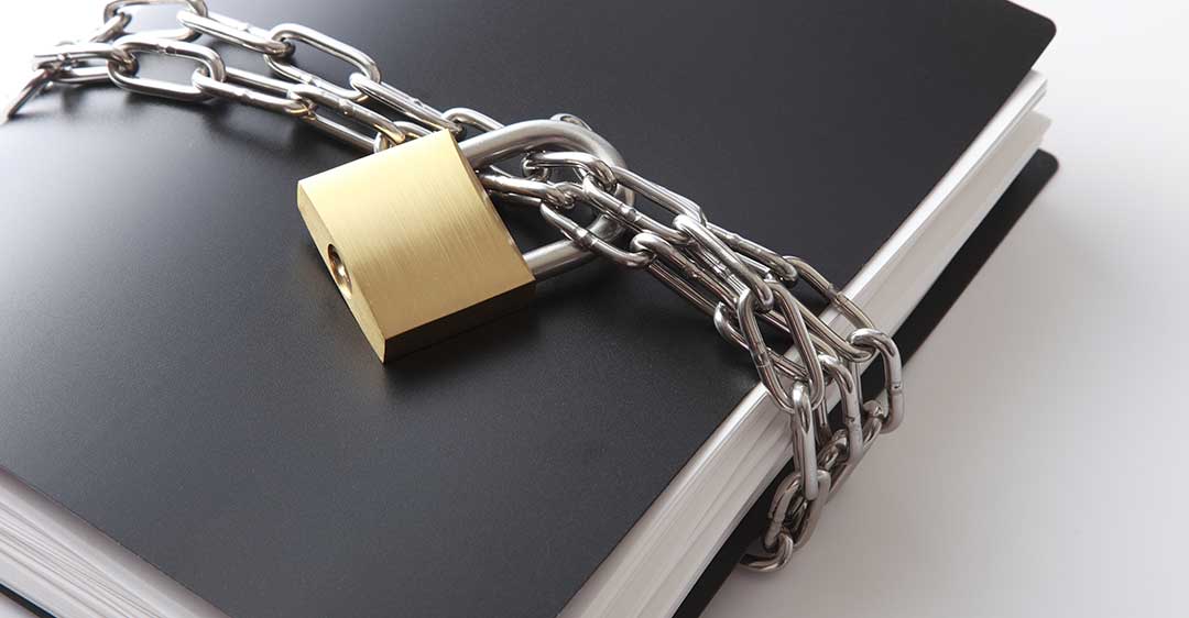 book wrapped in chain with padlock, Protect Confidential Information and Trade Secrets with a Non-Compete Agreement