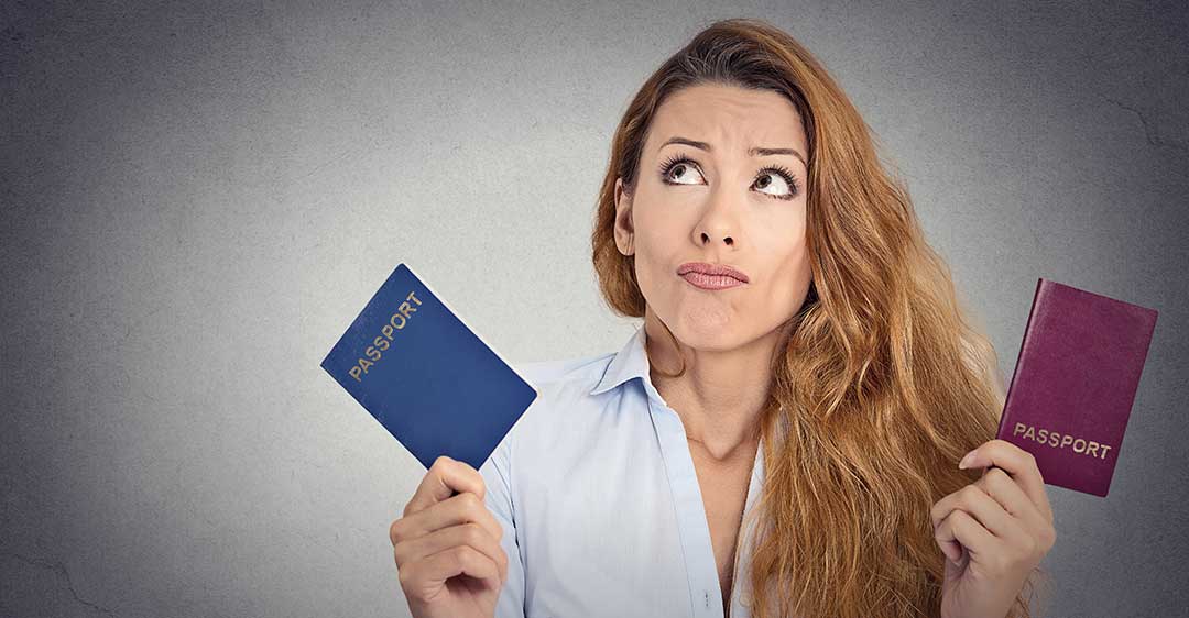 woman holding two passports with confused look, second passport problems