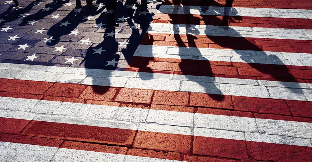 us flag painted on brick walkway with shadows of people walking, biden immigration rules impact business, international business