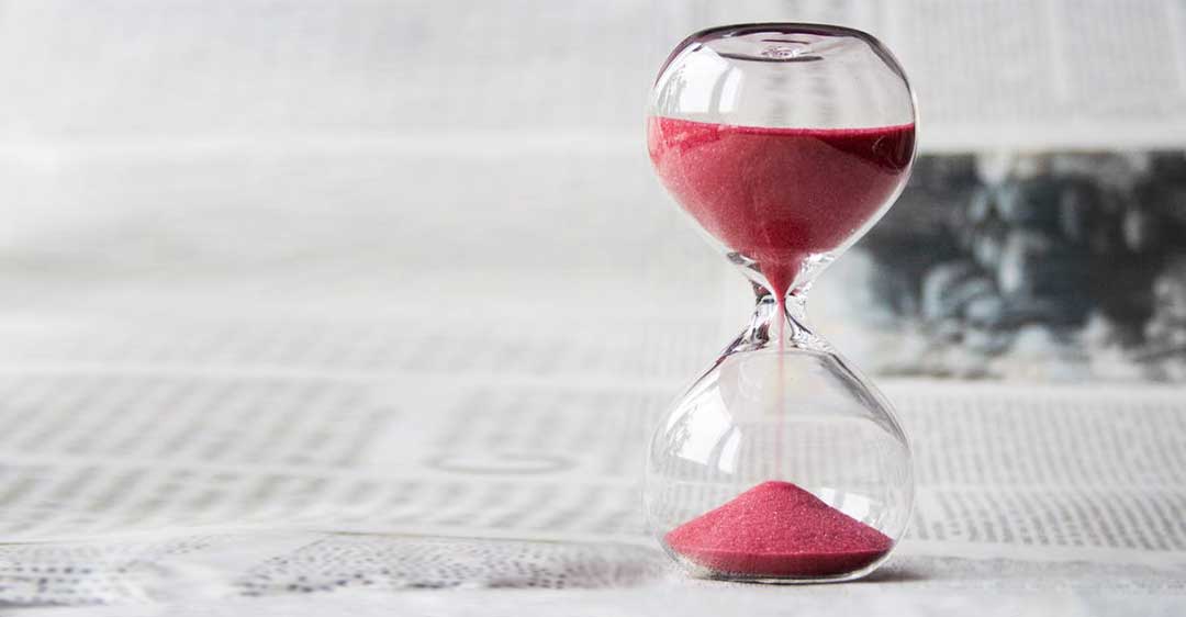 hourglass with red sand on newspaper, registered trademark excusable nonuse