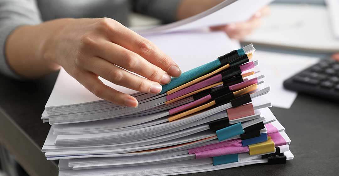 woman's hand on stack of documents, preserve evidence, preservation of evidence