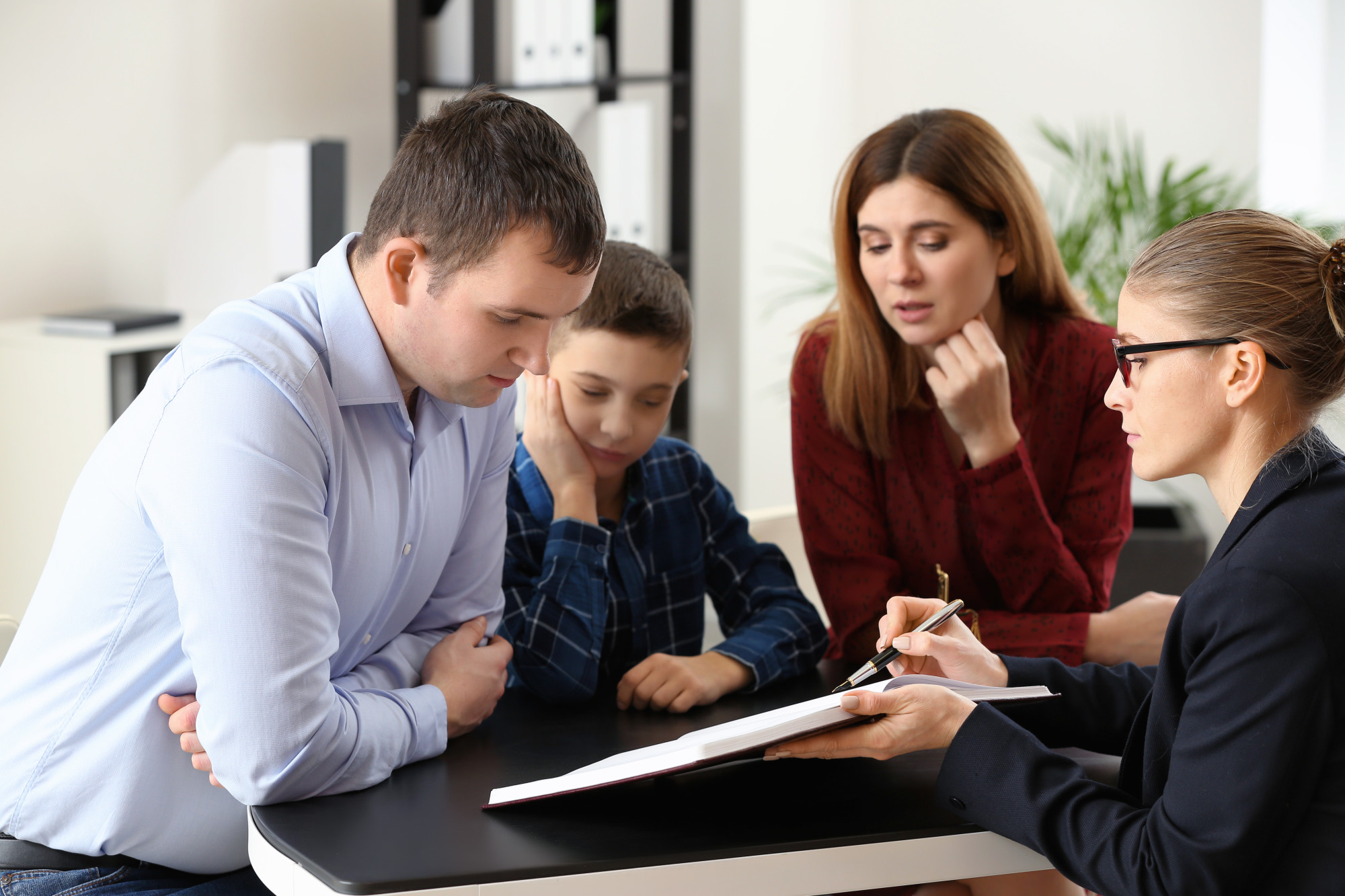 mother, father, and child reviewing document with attorney, filing for divorce, florida family law