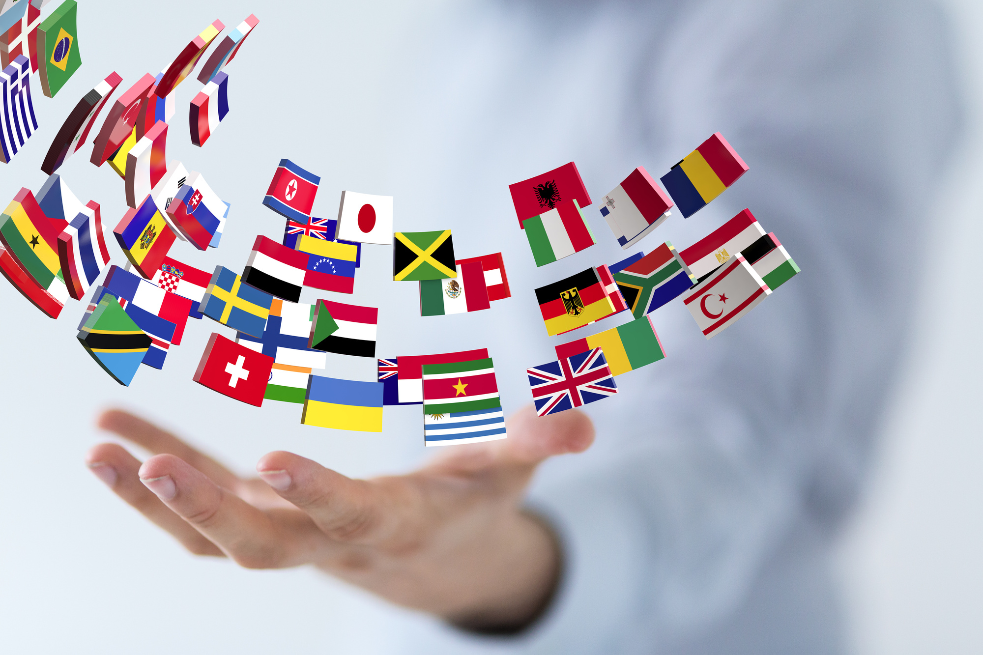country flag icons hovering over hand, international business law