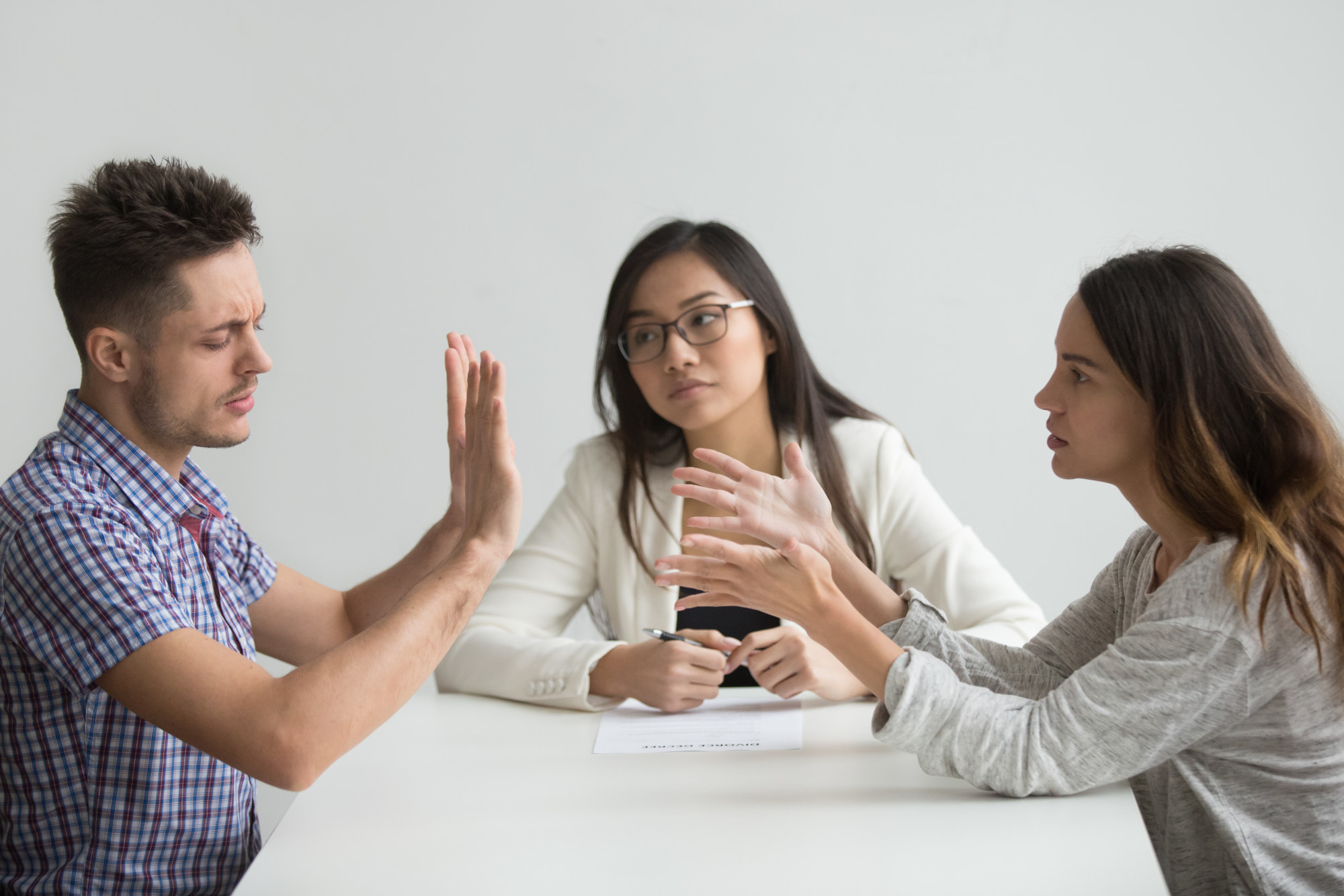 man and two women sitting at conference table, disagreement, inheritance litigation, inheritance dispute, will contest