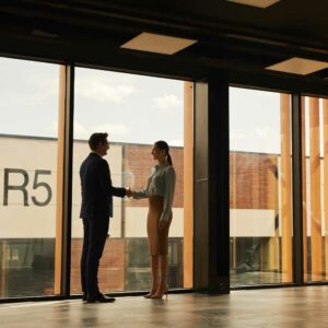 landlord and tenant shaking hands in office building, commercial lease