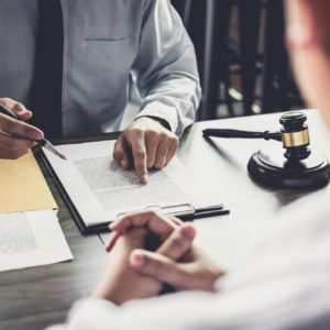 lawyer reviewing document with client, how to choose a business attorney in florida