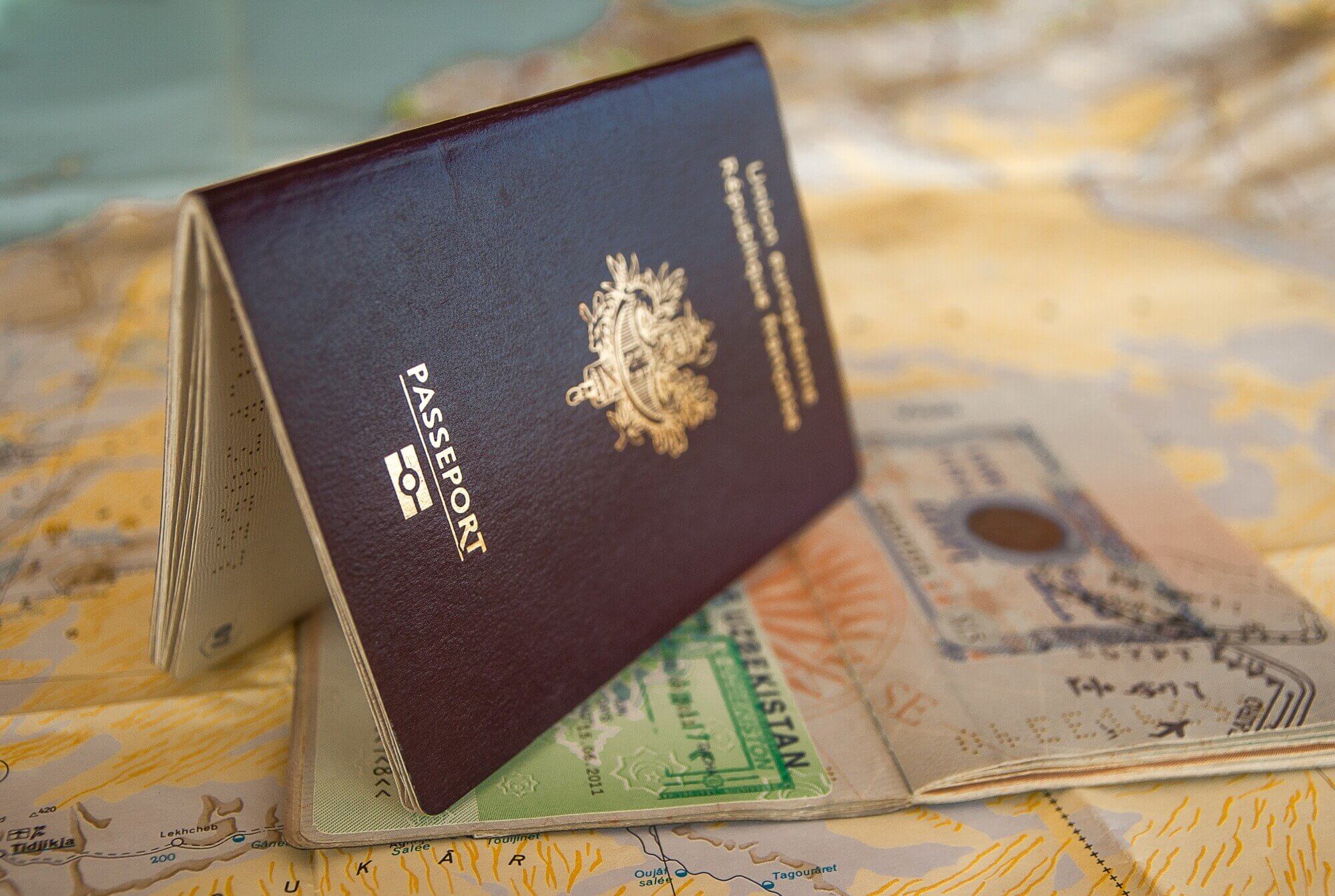 two passports atop a map, american citizenship by ancestry