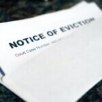 A close-up of a white envelope and a paper inside with the bold heading Notice of Eviction and a partially visible court case number, placed on a dark surface—typical documents handled by a civil litigation attorney in Florida.