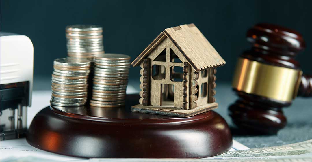 stack of coins and house with gavel, can creditors place a lien on a business, business liens